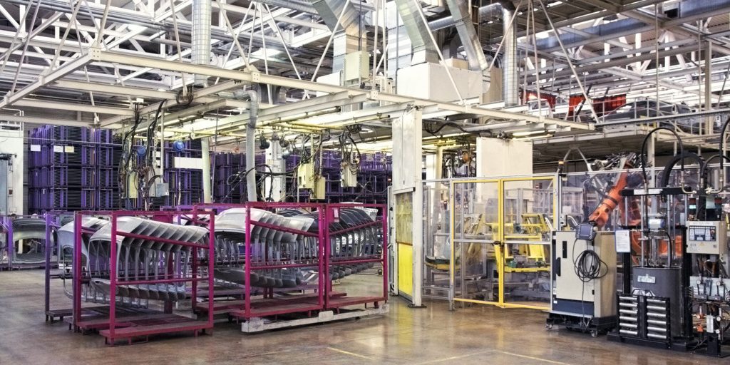 robotic arms in a car factory