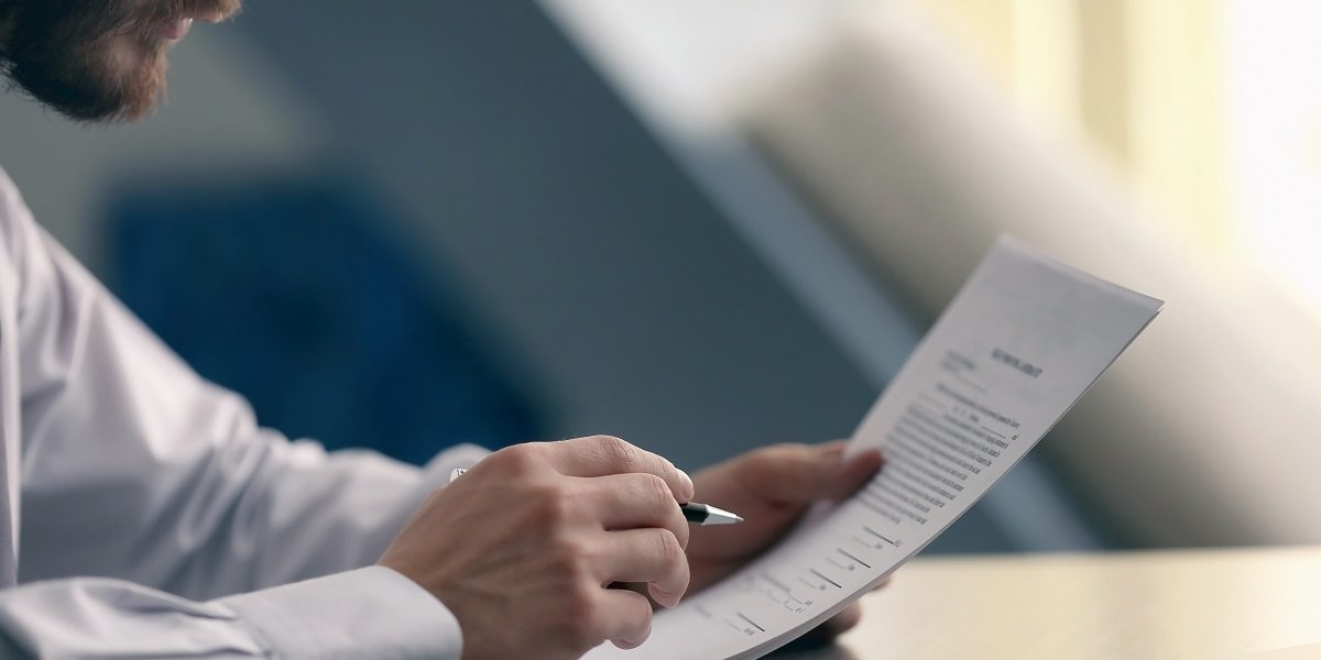 Businessman reading documents; Shutterstock ID 543880450; PO: blog